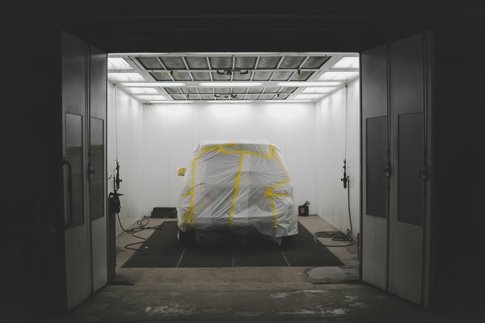 A vehicle masked up in the spray booth