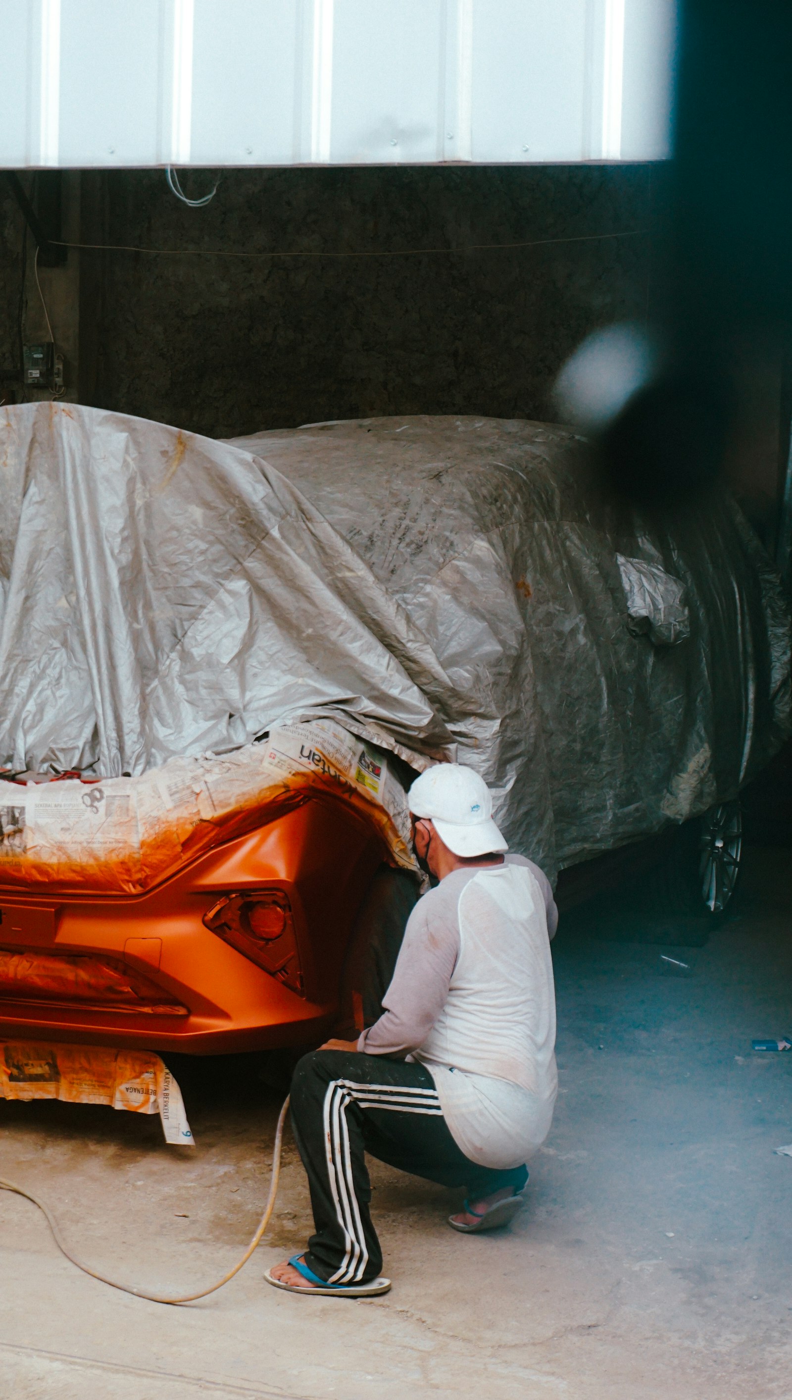 Technician preparing a vehicle for collision repair
